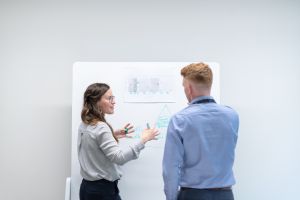 woman explainings something on a whiteboard