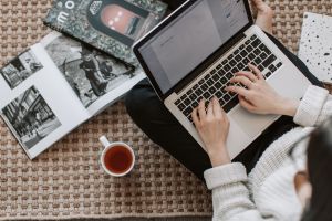 Woman writing on laptop