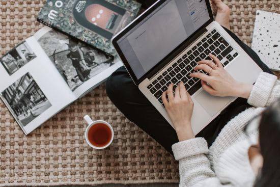 Woman writing on laptop