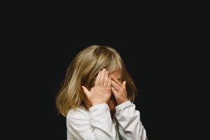 Girl covering her face